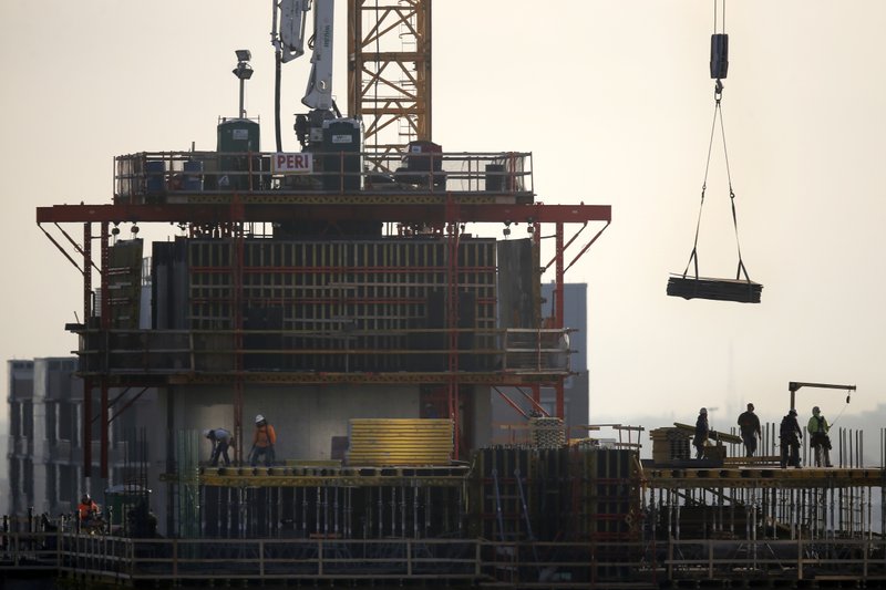 FILE - In this Jan. 18, 2017 file photo, construction personnel work on a building project just south of Chicago's Loop. The U.S. economy slowed in the final three months of last year to an annual growth rate of 2.6 percent, the slowest pace since the beginning of 2018, as the government shutdown and other factors took a toll on growth. Economists believe growth has slowed even more in the current quarter. (AP Photo/Charles Rex Arbogast)