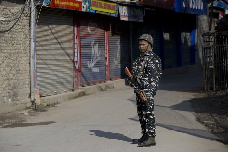 An Indian paramilitary soldier stands guard outside a closed market during a strike in Srinagar, Indian controlled Kashmir, Thursday, Feb. 28, 2019. As tensions escalate between India and Pakistan, shops and business remained closed for the second consecutive day in Indian portion of Kashmir following a strike call by separatist leaders to protest Tuesday's raids on key separatist leaders by Indian intelligence officers. (AP Photo/Dar Yasin)