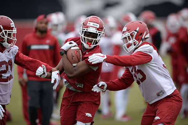 Arkansas receiver Shamar Nash runs after a catch during practice Friday, March 1, 2019, in Fayetteville. 