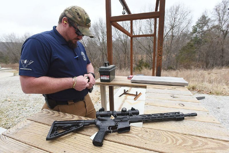 Guy Joubert, director of manufacturing at Wilson Combat, loads the magazine of a Protector Series rifle at the company’s headquarters near Berryville in Carroll County. 