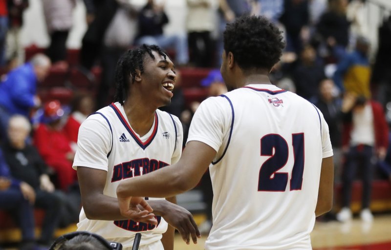Detroit Mercy guards Antoine Davis, left, and Lamar Hamrick (21) greet each other after the team's 87-85 win over IUPUI in an NCAA college basketball game, Thursday, Feb. 28, 2019, in Detroit. Davis broke Stephen Curry's freshman 3-point record early in the second half and finished with 20 points. Davis swished a 30-footer from the right wing for shot No. 123 beyond the arc to surpass the mark Curry set at Davidson 12 years ago. (AP Photo/Carlos Osorio)