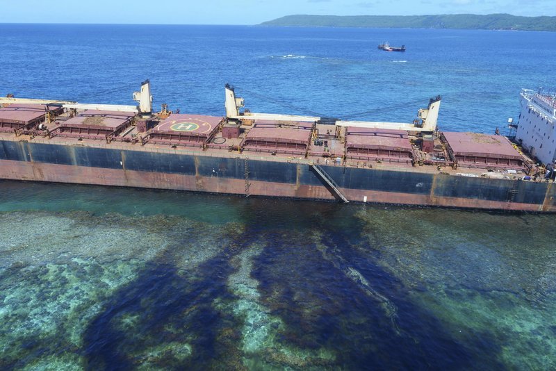 In this Feb. 26, 2019, photo taken by the Australian Maritime Safety Authority near Rennell Island in the Solomon Islands shows the &#x201c;MV Solomon Trader&#x201d; ship which ran aground Feb. 5. Australian officials say an environmental disaster is unfolding in the Solomon Islands after the ship ran aground and began leaking oil next to a UNESCO World Heritage site. (The Australian High Commission Solomon Islands via AP)