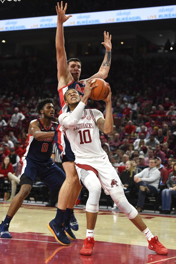 Arkansas forward Daniel Gafford (10) tries to get past Mississippi defender Dominik Olejniczak (13) during the first half of an NCAA college basketball game, Saturday, March 2, 2019 in Fayetteville, Ark. (AP Photo/Michael Woods)