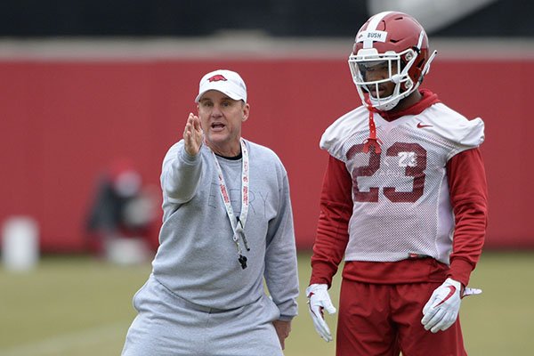 Arkansas coach Chad Morris (left) instructs freshman defensive back Devin Bush during a practice Friday, March 1, 2019, in Fayetteville. 