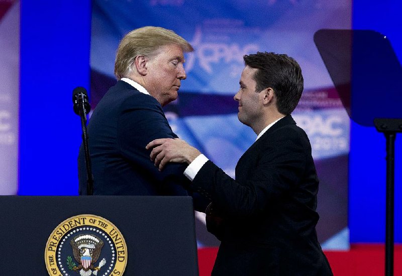 President Donald Trump welcomes conservative activist Hayden Williams to the stage Saturday at the Conservative Political Action Conference. Williams was attacked while recruiting at the University of California, Berkeley. Trump cited the case Saturday in announcing plans for an executive order to ensure free speech by students of all political viewpoints at colleges and universities. 