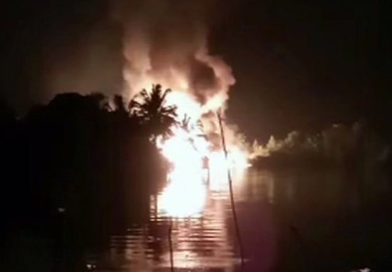 In this image made from video on Friday, March 1, 2019, fire is seen from a pipeline explosion in Nembe, Nigeria. More than 50 people are missing after a leaking oil pipeline exploded and caused a stampede in southern Nigeria, a local official said Saturday. The blast early Friday caused massive oil spillage in the Nembe kingdom in Bayelsa state, the Nembe Chiefs Council spokesman, Chief Nengi James-Eriworio, told The Associated Press. (AP Photo)