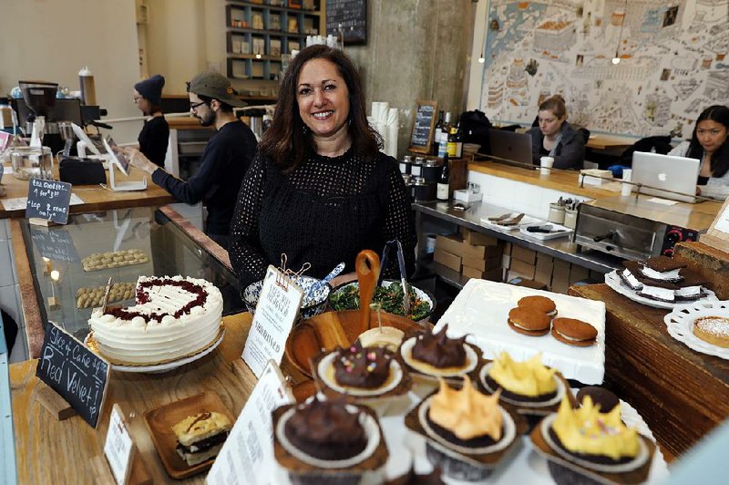 Dawn Casale, shown last month in her One Girl Cookies shop in the Brooklyn borough of New York, says she doesn’t oppose a proposal to require that private businesses provide paid time off for employees, but she feels that the city needs to help small businesses make ends meet.