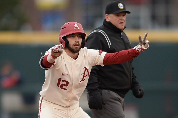 Arkansas catcher Casey Opitz signals to the Razorback dugout after hitting an RBI double Stony Brook Saturday, March 2, 2019, during the inning at Baum-Walker Stadium in Fayetteville. 