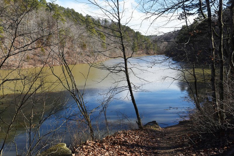 NWA Democrat-Gazette/FLIP PUTTHOFF Black Bass Lake, seen in January , has an aura of wilderness, but it's right in the middle of Eureka Springs. A one-mile trail circles the small lake.