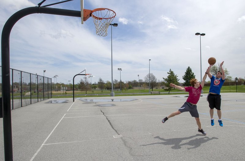 File Photo/NWA Democrat-Gazette/J.T. WAMPLER Zach Sjogren of Bella Vista (right) and Austin Walker of Rogers play some 1 on 1 basketball at Memorial Park in Bentonville in March 2017.