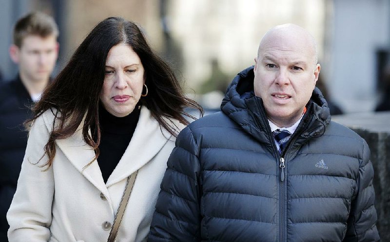 Former Adidas executive James Gatto (right) and his wife Rachel Gatto arrive in court in New York on Tuesday. James Gatto and two other men were sentenced to less than one year apiece in minimum- security prison because of fraud for channeling secret payments to the families of top-tier basketball recruits to influence where the players went to school. 