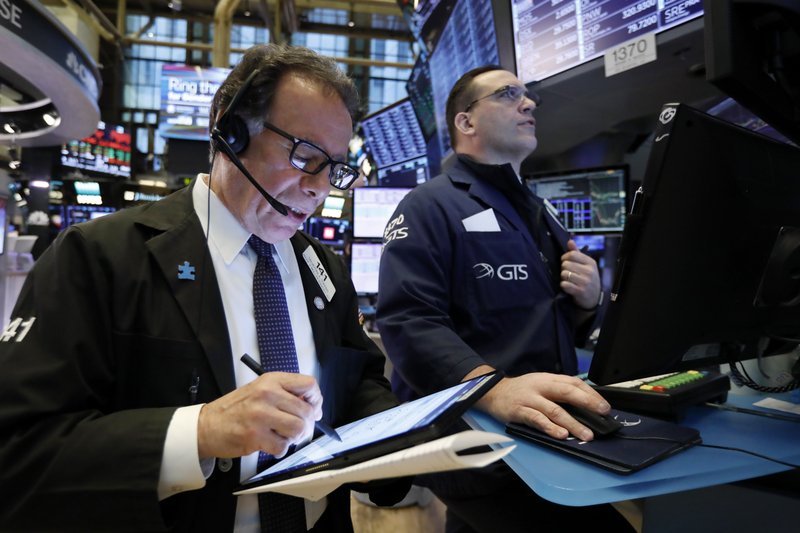 Trader Sal Suarino, left, and specialist Anthony Matesic work on the floor of the New York Stock Exchange, Tuesday, March 5, 2019. Stocks are opening slightly lower on Wall Street led by losses in banks and technology companies. (AP Photo/Richard Drew)