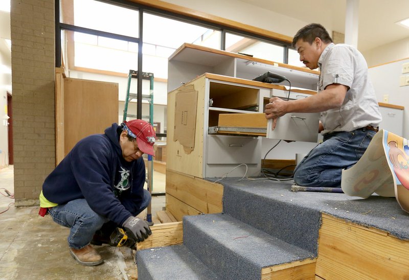 Antonio Sanchez (left) and Gustavo Salazar, both with Pick-it Construction, Inc., continue renovation work Friday, March 1, 2019, on the Control Station area of the former Washington County Emergency Operations Center in Fayetteville. The building is being converted to the Washington County Crisis Stabilization Unit.