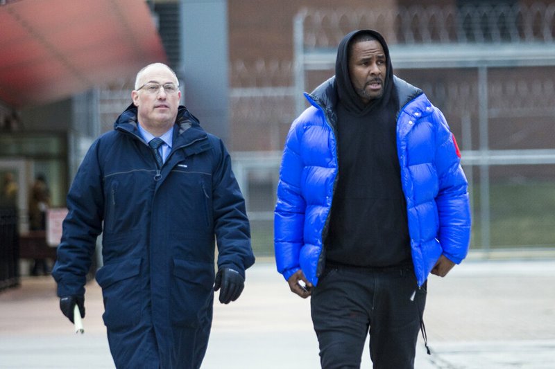 In this Monday, Feb. 25, 2019 file photo, R. Kelly walks out of Cook County Jail with his defense attorney, Steve Greenberg, after posting $100,000 bail, in Chicago. In his first interview since being charged with sexually abusing four people, including three underage girls, R. Kelly says he "didn't do this stuff" and he's "fighting for his life. Kelly gave the interview to Gayle King of "CBS This Morning," with excerpts airing Tuesday night, March 5, 2019, and the full interview airing Wednesday and Thursday morning. (Ashlee Rezin/Chicago Sun-Times via AP, File) story.lead_photo.caption