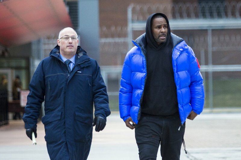 In this Monday, Feb. 25, 2019 file photo, R. Kelly walks out of Cook County Jail with his defense attorney, Steve Greenberg, after posting $100,000 bail, in Chicago. In his first interview since being charged with sexually abusing four people, including three underage girls, R. Kelly says he "didn't do this stuff" and he's "fighting for his life. Kelly gave the interview to Gayle King of "CBS This Morning," with excerpts airing Tuesday night, March 5, 2019, and the full interview airing Wednesday and Thursday morning. (Ashlee Rezin/Chicago Sun-Times via AP, File)