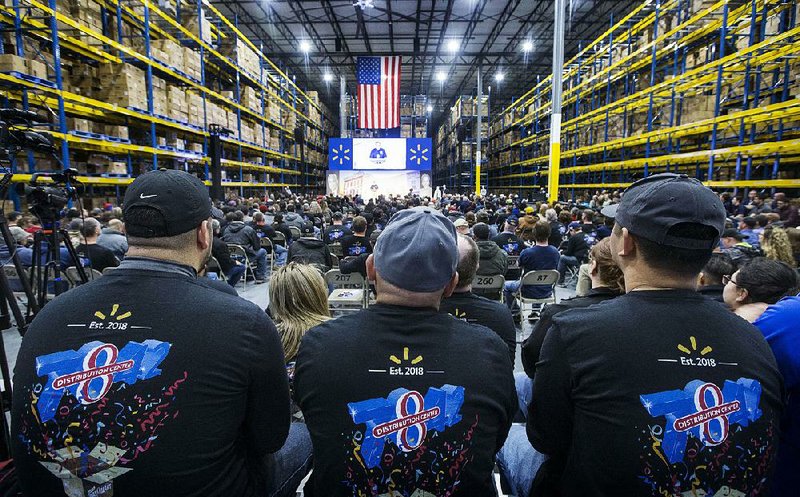 Walmart employees wear commemorative shirts at a ceremony last week opening Walmart’s distribution center dubbed DC 7842 in  Bentonville. 