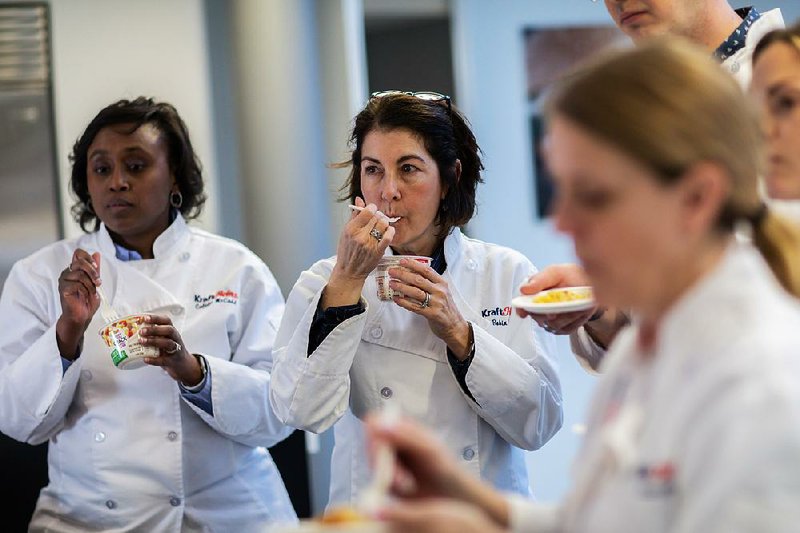 Robin Ross (center), culinary director at Kraft Heinz, with associates Colette McCadd  (left) and others, tastes versions of Just Crack an Egg breakfast scrambles recently at the Kraft Heinz Innovation Center in Glenview, Ill. 