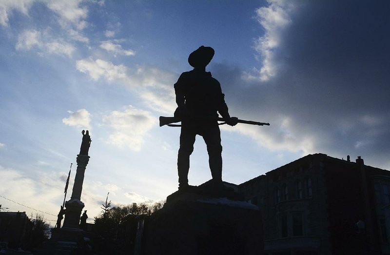 The sun sets Thursday behind a monument honoring veterans of the Spanish American War in Pottsville, Pa. 