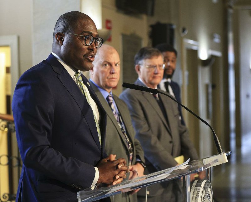 FILE - Mayor Frank Scott Jr. (left), along with  (left to right) Little Rock interim Police Chief Wayne Bewley, City Attorney Tom Carpenter and Chief Deputy City Attorney Alex Betton answer questions on March 7, 2019, during a press conference about the release of dashboard-camera footage from a fatal Feb. 22 officer-involved shooting. 