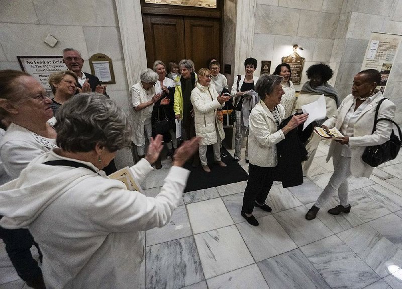 A crowd applauds Sen. Joyce Elliott on Thursday at the state Capitol after she unsuccessfully sought approval of an effort to ratify the Equal Rights Amendment. Elliott said she was “heartbroken” after the resolution died in committee. 