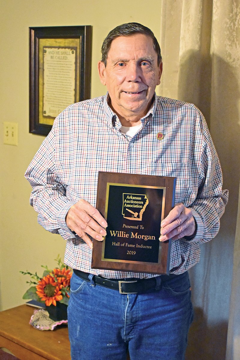 Willie Morgan of Heber Springs holds the plaque he received for being inducted into the Arkansas Auctioneers Association Hall of Fame during the association’s annual meeting Feb. 2 in Hot Springs. Morgan, 75, has been an auctioneer for 57 years.