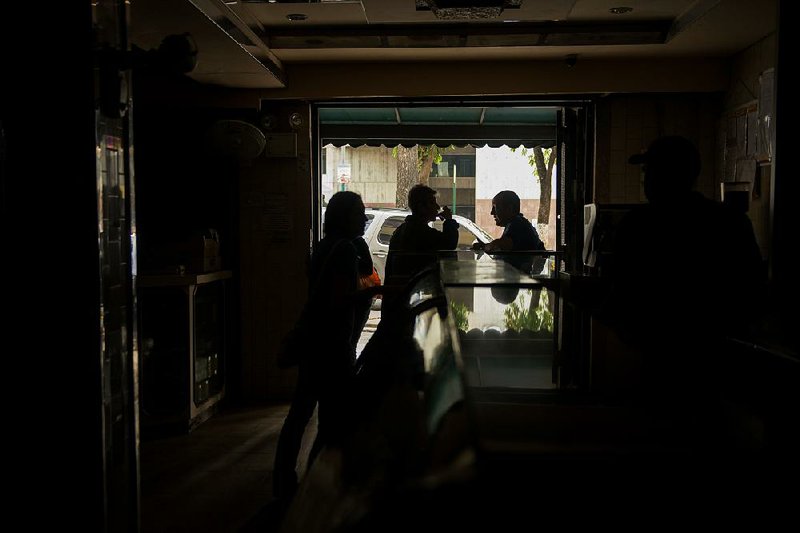 A bakery sits dark Friday in Caracas as a power failure extends from Venezuela’s capital to 22 of 23 states. The bakery’s owner worried that his refrigerated goods would spoil before electricity could be restored. 