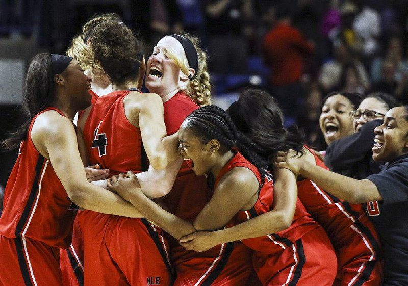 Fort Smith Northside celebrates after sophomore guard Jersey Wolfenbarger’s 12-foot jumper with 2.4 seconds left gave Northside a come-from-behind 36-34 victory over Bentonville in the Class 6A girls state basketball championship on Friday at Bank OZK Arena in Hot Springs. For more photos, visit arkansasonline.com/308girls6a/.