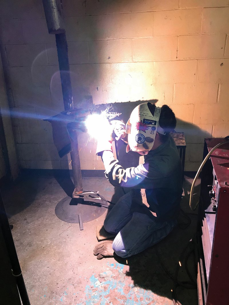 Garrett Holloway, a senior at Pangburn High School and a welding student at the Arkansas State University-Beebe Searcy campus, welds in the overhead position using the shielded metal car welding process. Holloway recently won a $15,000 scholarship to Arkansas Elite Welding Academy after finishing first in a skills competition Feb. 16.