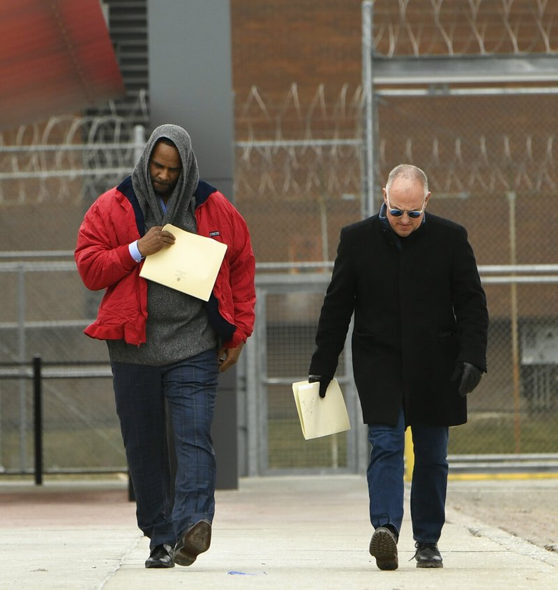 Singer R. Kelly left, walks with his attorney Steve Greenberg right, after being released from Cook County Jail, March 9, 2019, in Chicago. (AP Photo/Paul Beaty)