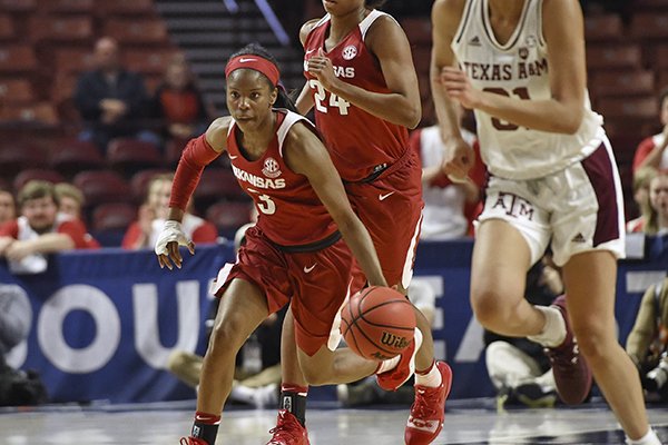 Arkansas' Malica Monk (3) and Taylah Thomas (24) bring the ball up the court past Texas A&amp;M's N'dea Jones during the first half of an NCAA college basketball game in the Southeastern Conference women's tournament Saturday, March 9, 2019, in Greenville, S.C. (AP Photo/Richard Shiro)

