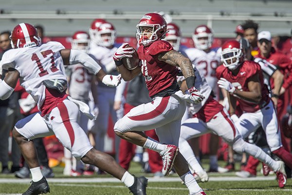 Arkansas running back Devwah Whaley carries the ball during a scrimmage Saturday, March 9, 2019, in Fayetteville. 