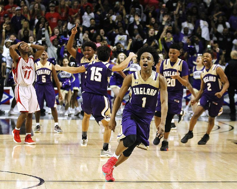 Kevante Davis (1) and the rest of England’s players celebrate after their double-overtime victory over Clarendon in the Class 2A boys state championship game Saturday at Hot Springs. 