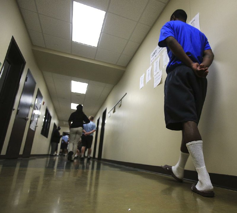  Arkansas Democrat-Gazette/STATON BREIDENTHAL --6/24/14-- Boys are escorted by staff in the school at the Arkansas Juvenile Assessment and Treatment Center near Alexander. The facility is the state's largest juvenile lockup. 