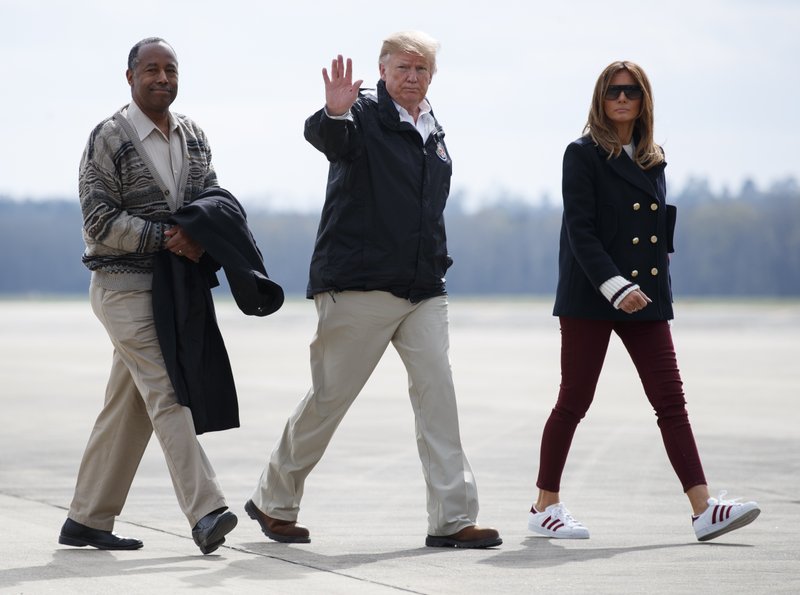 President Donald Trump, first lady Melania Trump and Secretary of Housing and Urban Development Ben Carson walk from Marine One to board Air Force One at Lawson Army Airfield, Fort Benning, Ga., Friday, March 8, 2019, en route Palm Beach International Airport in West Palm Beach, Fla., after visiting Lee County, Ala., where tornados killed 23 people. (AP Photo/Carolyn Kaster)