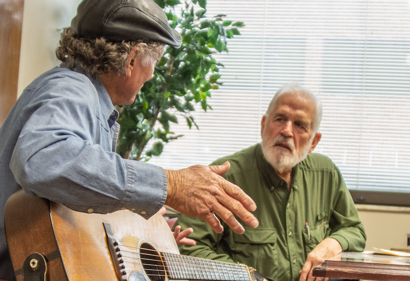 Songwriter Wood Newton (left), formerly of Hampton, Ark., listens as veteran William Newton (no relation) tells about his time in Vietnam during a Feb. 15-16 retreat for the Little Rock Chapter of Operation Song, held at the Eugene J. Towbin Veterans Healthcare Center in North Little Rock. The nonprofit Operation Song, of which Wood Newton is a part, brings Nashville songwriters together with veterans, active duty military members and their families to heal through songwriting. (Arkansas Democrat-Gazette/CARY JENKINS)