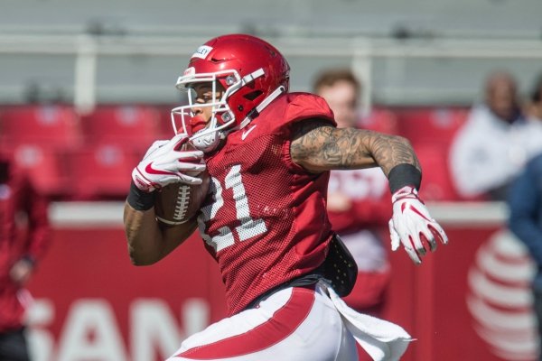 Devwah Whaley, Arkansas running back, carries in a scrimmage Saturday, March, 9, 2019, during spring practice at Razorback Stadium in Fayetteville.