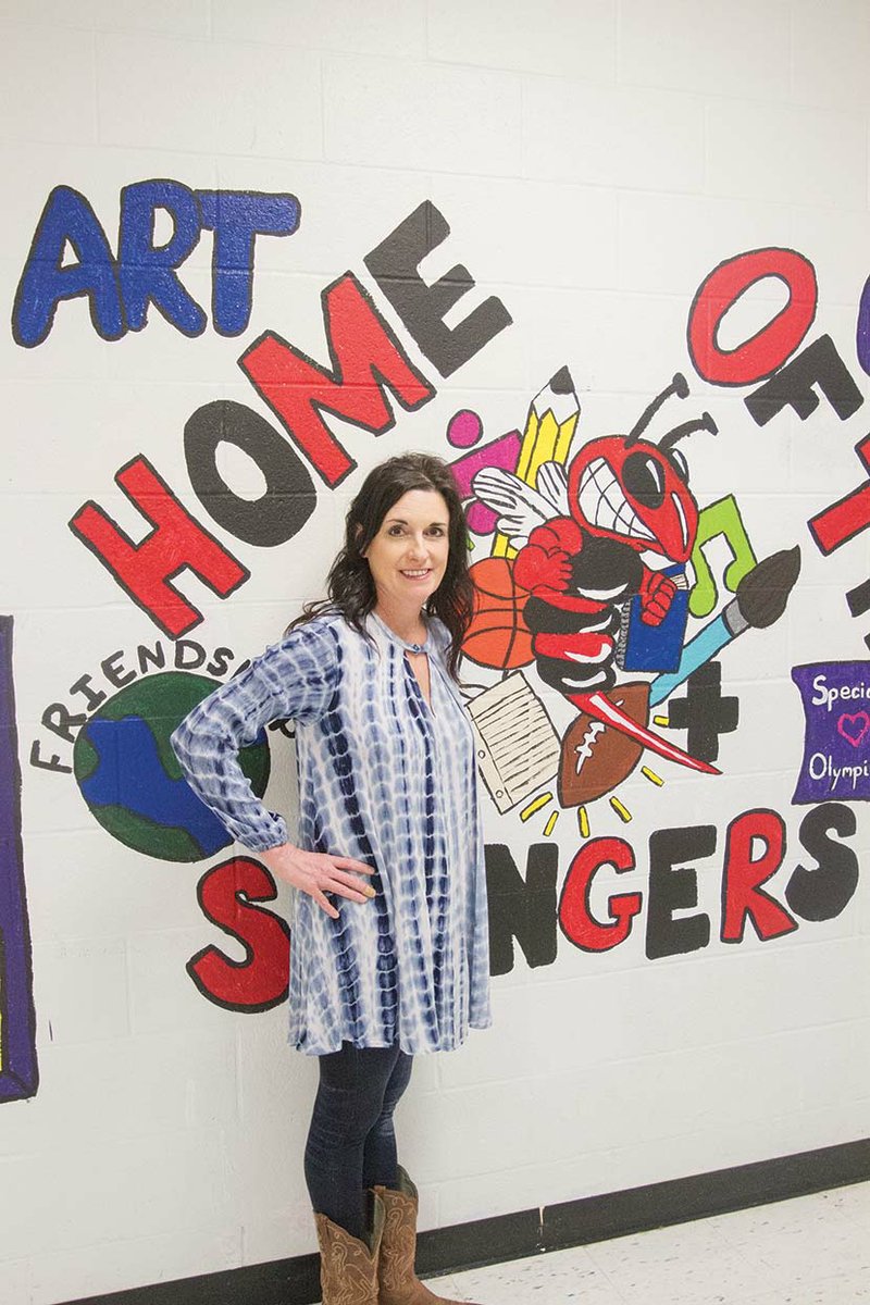 Ashley Washam stands in front of a mural in Maumelle Middle School, where she teaches a life-skills class. Washam was named Educator of the Year by the Maumelle Area Chamber of Commerce. Her 21-year career includes teaching at public schools, as well as a private facility. “I enjoy it, and I just enjoy seeing [the students] happy.”