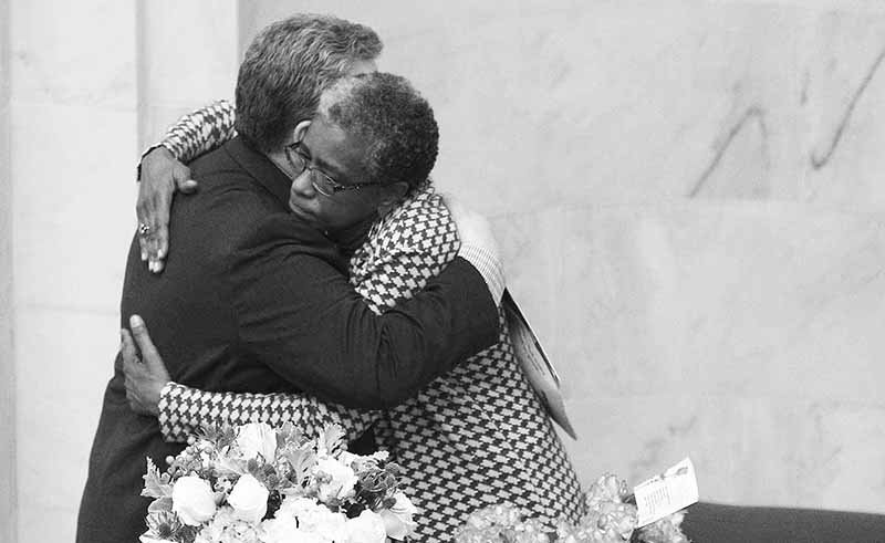 Arkansas Democrat-Gazette/Staton Breidenthal EMBRACE: Sen. Stephanie Flowers, right, D-Pine Bluff, hugs Sen. Alan Clark, R-Lonsdale, Monday after Clark spoke in the Senate about events in a committee meeting last week.