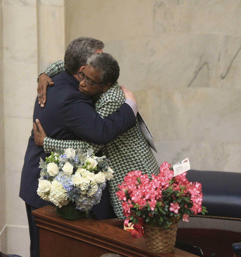 Sen. Stephanie Flowers, D-Pine Bluff, hugs Sen. Alan Clark, R-Lonsdale, after Clark spoke Monday in the Senate about events in a committee meeting last week. 