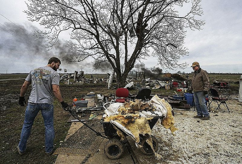 Property owners remove remnants of a former antique store in Lonoke County on March 10, 2019, after an EF1 tornado struck the area the morning prior. The storm system that also affected Magnolia brought up to 110 mph wind gusts in central Arkansas, according to the National Weather Service