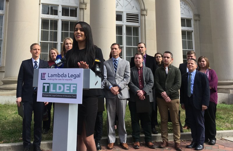 Lambda Legal lawyer Taylor Brown addresses reporters to announce a lawsuit on Monday, March 11, 2019, in Durham, North Carolina, arguing that North Carolina's state health plan for state employees discriminates by not covering hormone treatment and surgery for transgender people. (AP Photo/ Jonathan Drew)