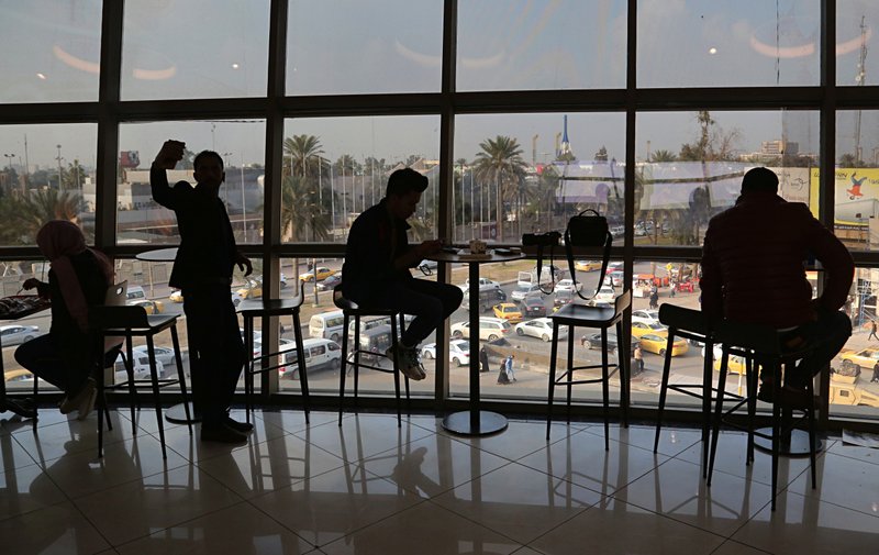 In this Feb. 10, 2019 photo, people eat in a restaurant at a shopping mall in Baghdad, Iraq. For the first time in years, Iraq is not at war. The defeat of the Islamic State group in late 2017 after a ruinous four-year conflict has given the population a moment of respite, and across the capital Baghdad there is a guarded sense of hope. (AP Photo/Khalid Mohammed)