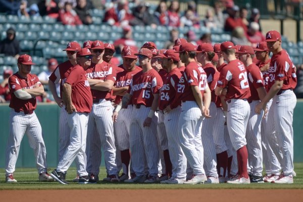 Arkansas Razorbacks players meet during a baseball game, Saturday, March 9, 2019 at Baum Stadium in Fayetteville.
