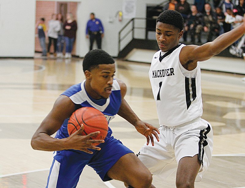 Terrance Armstard/News-Times Smackover's Jaqueze Modica defends Strong's Derrion Davis during their game at Smackover during the 2018-19 season. Earlier this week, Modica and Davis earned All-State honors.
