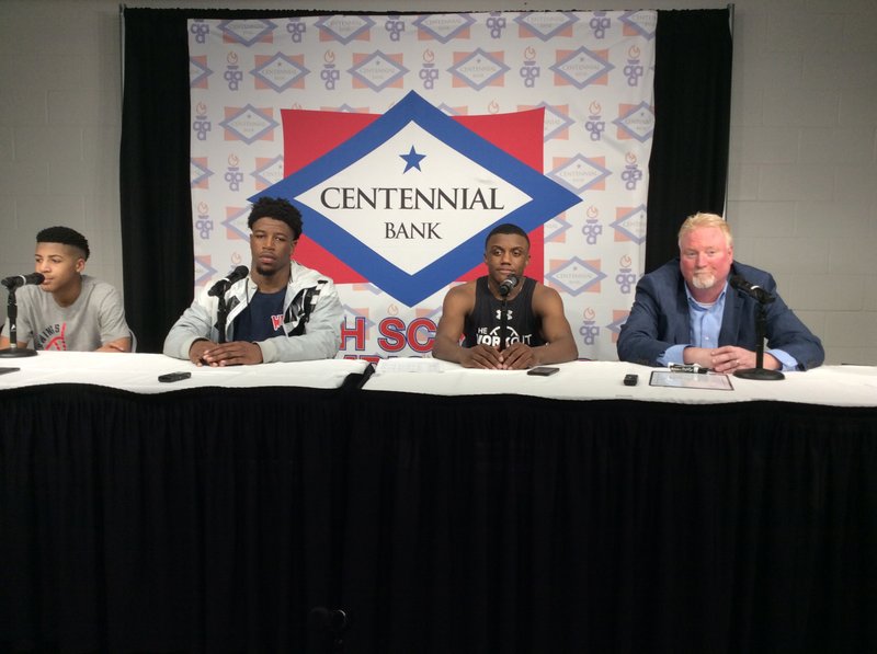 Colby Garland (from left), Kadyn Roach, Derrian Ford and Coach Dyun Long addressed questions from the media after winning the Class 4A State Basketball Championship on Saturday. After sitting down, Garland joked and said it was like an NBA press conference. “I’m going to do what the NBA players do and see if they are on,” said Garland, who then tapped his microphone.