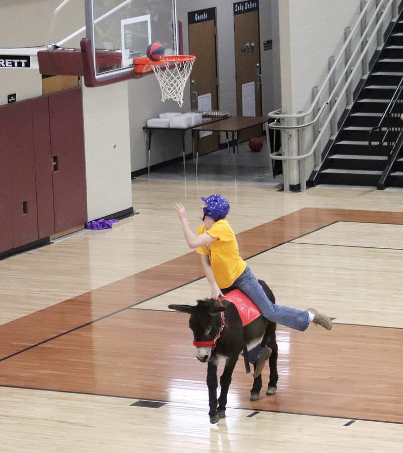 Nicholas Pohlman, a member of Prairie Grove FFA, tries to score during Donkey Basketball last week at Lincoln gym. Prairie Grove FFA defeated Lincoln FFA during the second basketball game of the night. Prairie Grove also won the championship game against the Stubborn Aces, an all-female team of Lincoln faculty members.