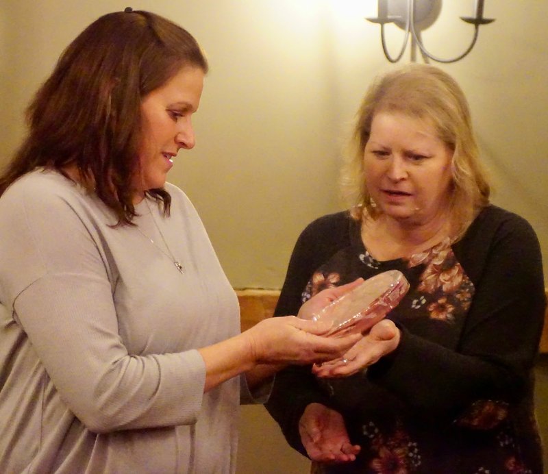 Westside Eagle Observer/RANDY MOLL Kelli Deen Mathews (left) receives the citizen of the year award from Tammie Runyan, president of the Gentry Chamber of Commerce, at an awards banquet on Thursday in Gentry.