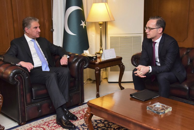 In this photo released by the Pakistan Foreign Office, Pakistani Foreign Minister Shah Mahmood Qureshi, left, meets with German Foreign Minister Heiko Maas in Islamabad, Pakistan, Tuesday, March 12, 2019. Qureshi said Tuesday that "progress has been made" at ongoing peace talks in Qatar between the Taliban and the U.S. that have stretched over two weeks. (Pakistan Foreign Office, via AP)