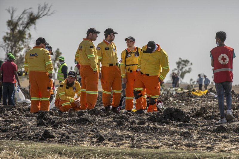 Investigators from Israel examine wreckage at the scene where the Ethiopian Airlines Boeing 737 Max 8 crashed shortly after takeoff on Sunday killing all 157 on board, near Bishoftu, or Debre Zeit, south of Addis Ababa, in Ethiopia Tuesday, March 12, 2019. Ethiopian Airlines had issued no new updates on the crash as of late afternoon Tuesday as families around the world waited for answers, while a global team of investigators began picking through the rural crash site. (AP Photo/Mulugeta Ayene)

