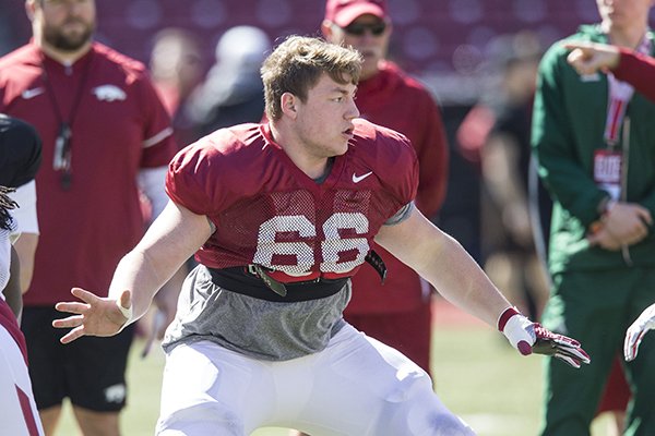 Arkansas center Ty Clary (66) goes through drills during practice Saturday, March 9, 2019, in Fayetteville. 